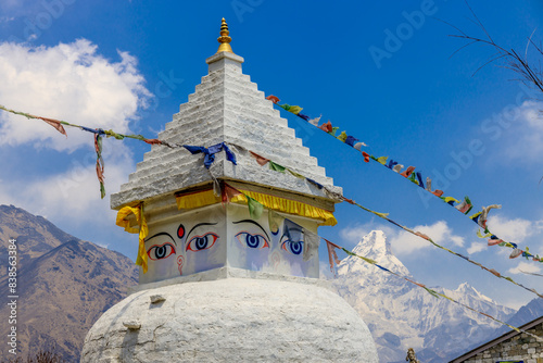 Stupa with Buddha eyes in Nepal. Religious building of buddhism pagoda in the high Himalaya mountains and Kathmandu capital city. Sacred place of Buddhism with prayer flags in beautiful peaceful place photo