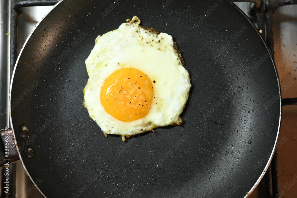 fried egg in frying pan healthy food runny yolk fried egg in frying pan healthy food runny yolk