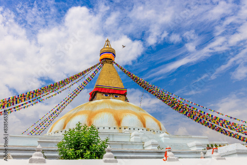 Stupa with Buddha eyes in Nepal. Religious building of buddhism pagoda in the high Himalaya mountains and Kathmandu capital city. Sacred place of Buddhism with prayer flags in beautiful peaceful place photo