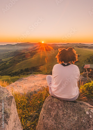 Curly haired woman staring into sunset