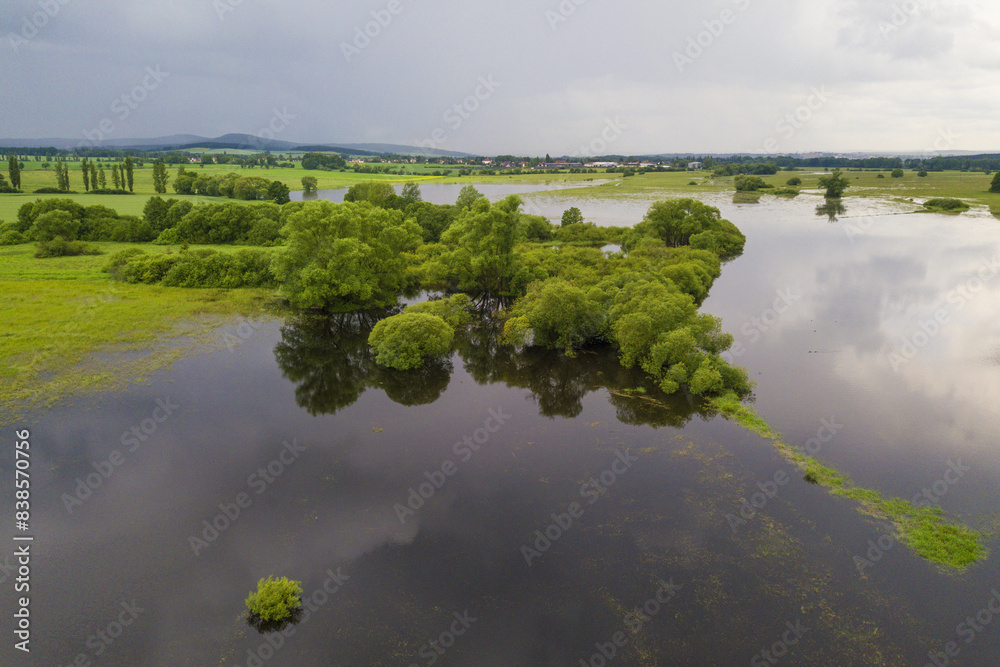 Flood in the countryside near the town Dobrany, West Bohemia, Czech republic, European union. Aerial view of flooded Radbuza river and landscape. Flood in the countryside near the town Dobrany, West Bohemia, Czech republic, European union. Aerial view of flooded Radbuza river and landscape.