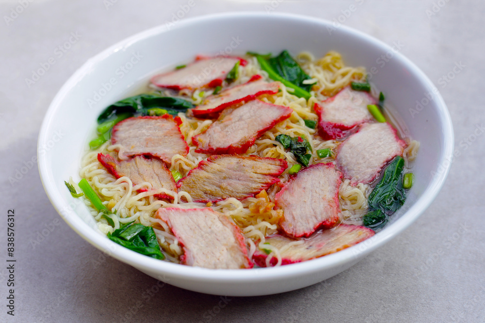 Chinese egg noodles with red pork in hot soup Chinese egg noodles with red pork in hot soup