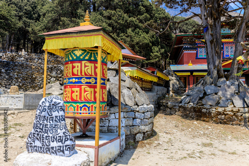 Nepal sacred stones mani with mantra written and carved on the surface. Prayer stones shire on the mountain trekking path on Everest Base Camp trek. Nepali buddhist mantra Om Mani Padme Hum on rock photo