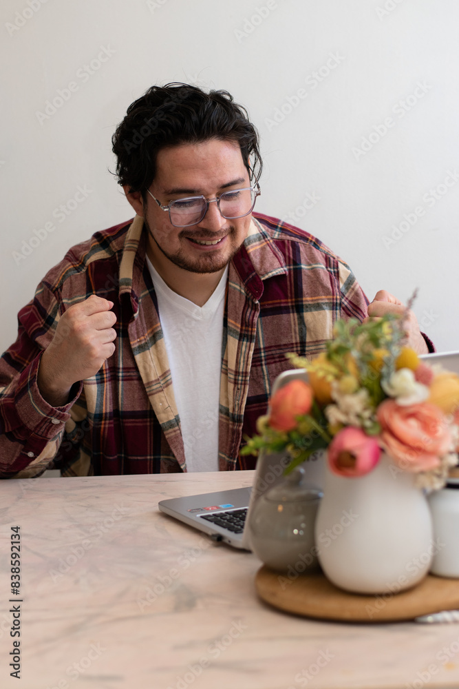 Young man using Glasses for firts time and get emotion gestures front his laptop in the living room Young man using Glasses for firts time and get emotion gestures front his laptop in the living room