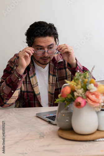 Young man using Glasses for firts time and get emotion gestures front his laptop in the living room