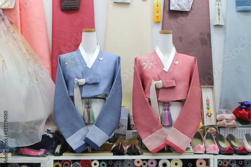 Pink and blue Korean hanbok jackets on display in dress shop
