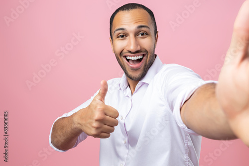 Amazed man in white shirt making pov photo showing like gesture