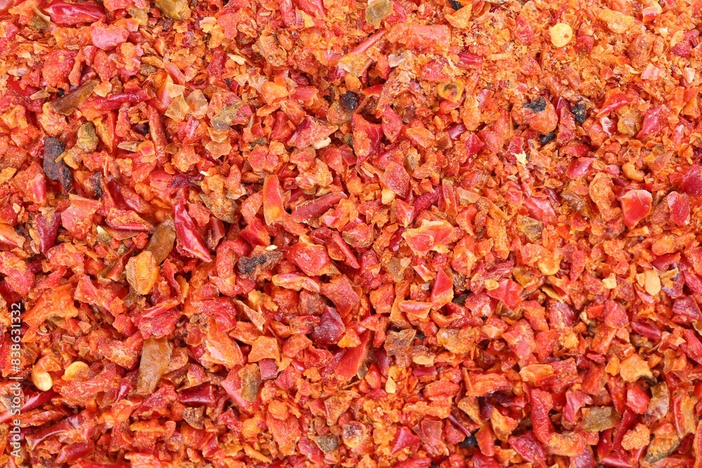 Aromatic spice. Red chili pepper flakes as background, top view Aromatic spice. Red chili pepper flakes as background, top view