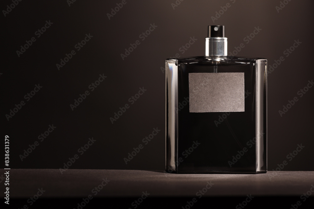 Luxury men`s perfume in bottle on grey table, space for text Luxury men`s perfume in bottle on grey table, space for text
