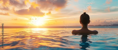 Serene image of a person relaxing in an infinity pool at sunset, with a view of the horizon. Perfect for concepts of relaxation and tranquility.