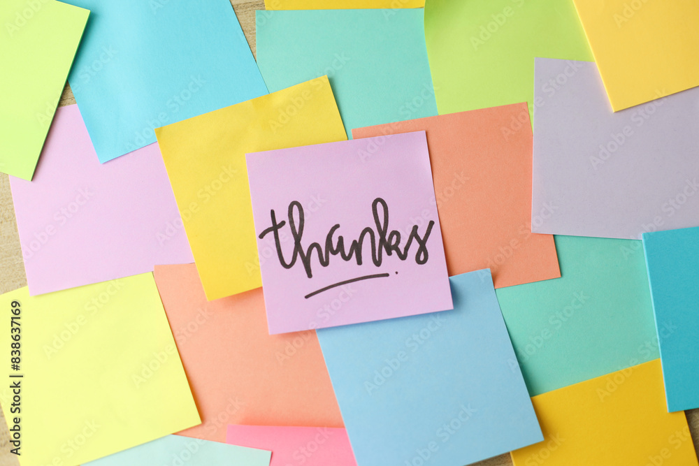 Thanks Written On Purple Sticky Note Over Colorful Background Thanks Written On Purple Sticky Note Over Colorful Background