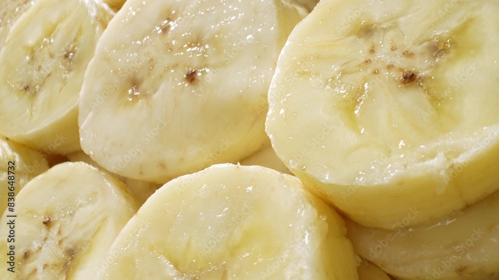 A mesmerizing close-up captures the creamy allure of sliced bananas. Each uniform piece unveils a soft, buttery texture, adorned with delicate brown speckles amidst its gentle yellow hue.
A mesmerizing close-up captures the creamy allure of sliced bananas. Each uniform piece unveils a soft, buttery texture, adorned with delicate brown speckles amidst its gentle yellow hue.