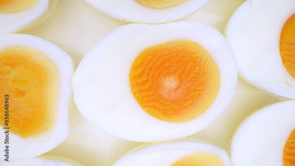 Zoom in, the boiled eggs lay exposed, their halves revealing rich, yellow yolks nestled within pristine white shells. A touch reveals their firm texture, a testament to their hard-boiled perfection.
Zoom in, the boiled eggs lay exposed, their halves revealing rich, yellow yolks nestled within pristine white shells. A touch reveals their firm texture, a testament to their hard-boiled perfection.
