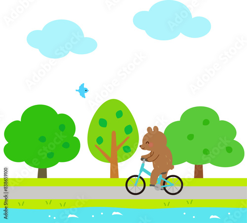 川沿いの道をサイクリングするクマのキャラクター