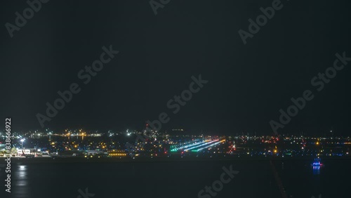 Time Lapse of Planes Landing at an Airport at Night photo