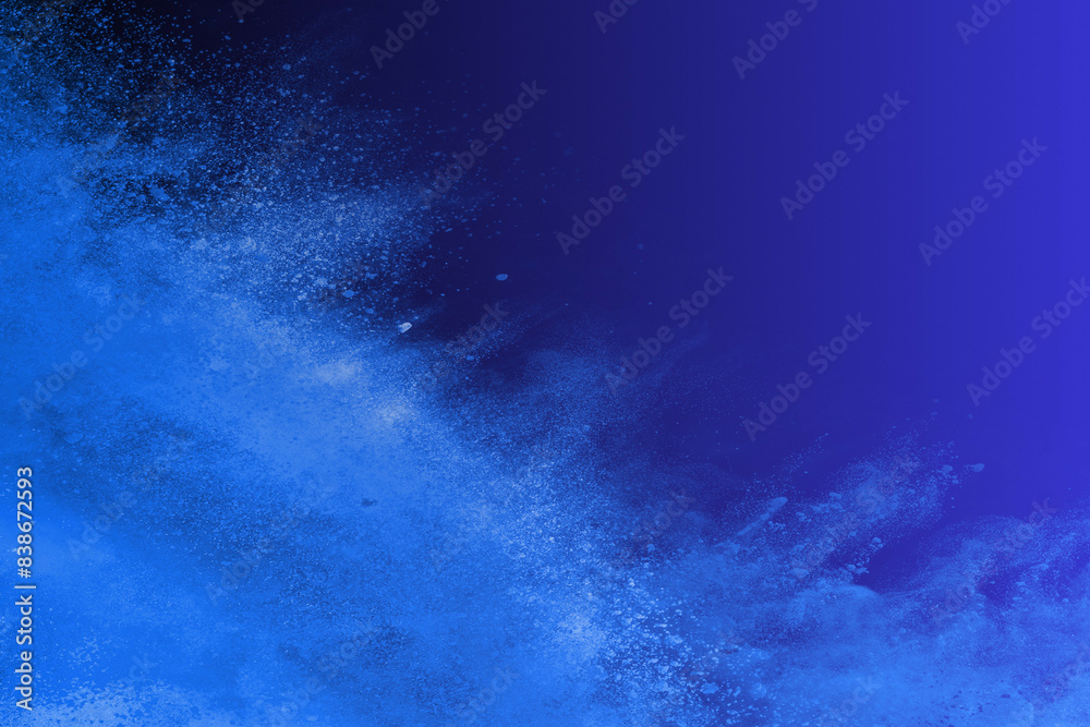 Obraz premium Explosión de polvos azules, fondo azul