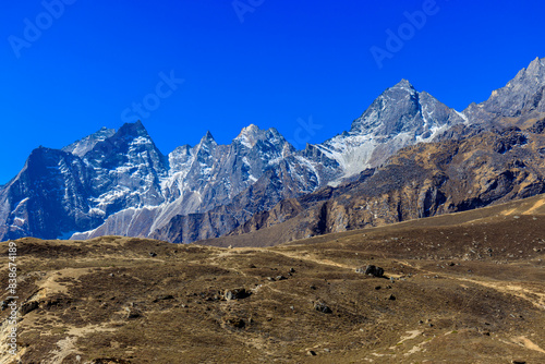 Himalaya mountains landscape with high altitude snow and ice glacier summit peaks. Everest Base Camp Solo Khumbu trekking region in Nepal. Beautiful Himalayas eight thouthander summits under blue sky