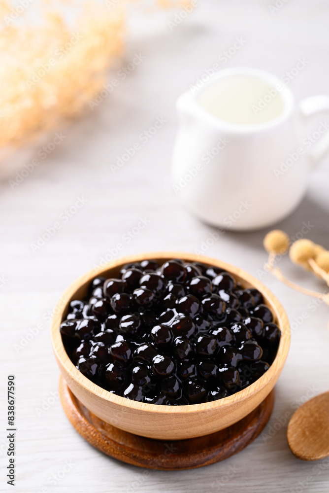 Black tapioca pearls or boba in wooden bowl, Ingredient in bubble tea Black tapioca pearls or boba in wooden bowl, Ingredient in bubble tea