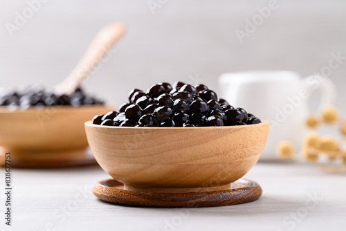 Black tapioca pearls or boba in wooden bowl, Ingredient in bubble tea