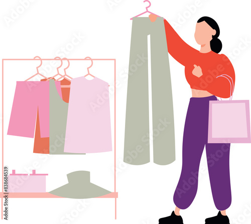 The girl is looking to the pants for buying.