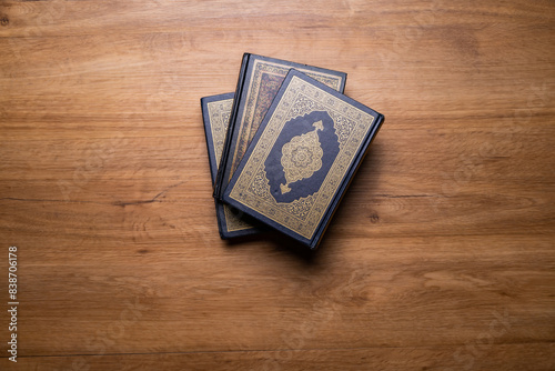 Ramadan, Eid mubarak, Islamic concept - The Holy Al Quran with written Arabic calligraphy meaning of Al Quran and rosary beads or tasbih, on wooden table, with copy space.