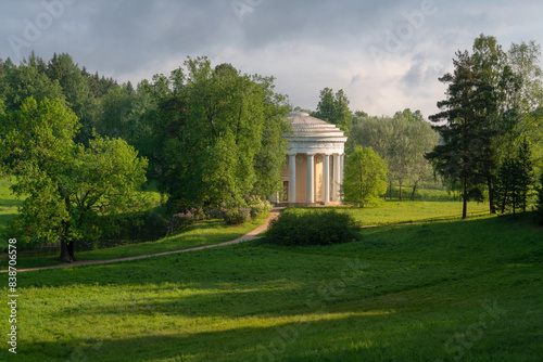 View of the Temple of Friendship on the bank of the Slavyanka River in the Pavlovsky Park on a sunny summer day, Pavlovsk, Saint Petersburg, Russia photo