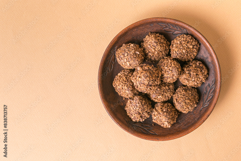 Healthy Homemade Energy Bites in a Rustic Wooden Bowl on Beige Background Healthy Homemade Energy Bites in a Rustic Wooden Bowl on Beige Background