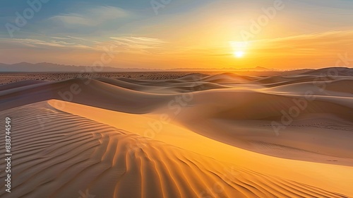 Tranquil and serene scene of a golden hour desert sunset over the vast rolling dunes   