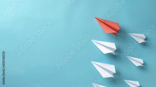 Red paper plane out of line with white paper to change disrupt and finding new normal way on blue background. 