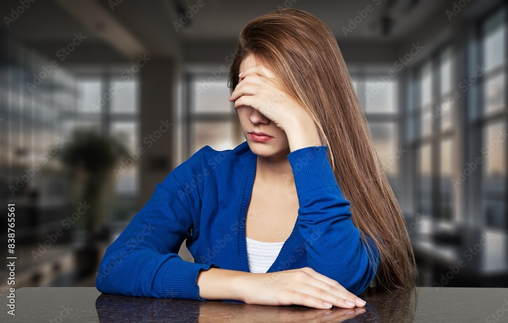 Upset depressed woman sitting in room, feeling lonely Upset depressed woman sitting in room, feeling lonely