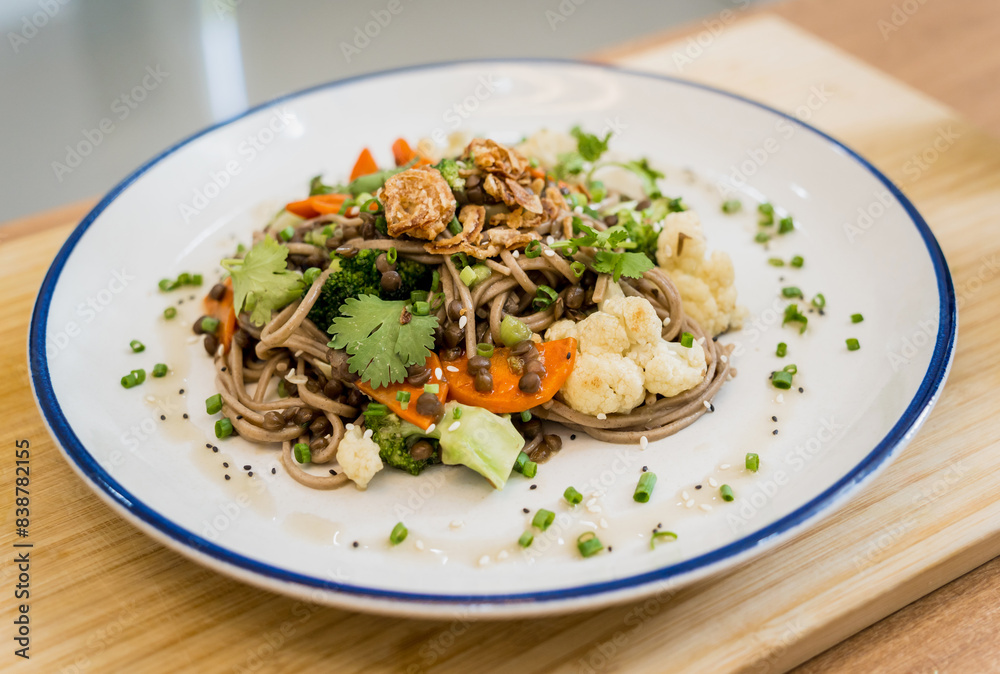 Japanese buckwheat pasta with lentils and vegetables in a bowl Japanese buckwheat pasta with lentils and vegetables in a bowl