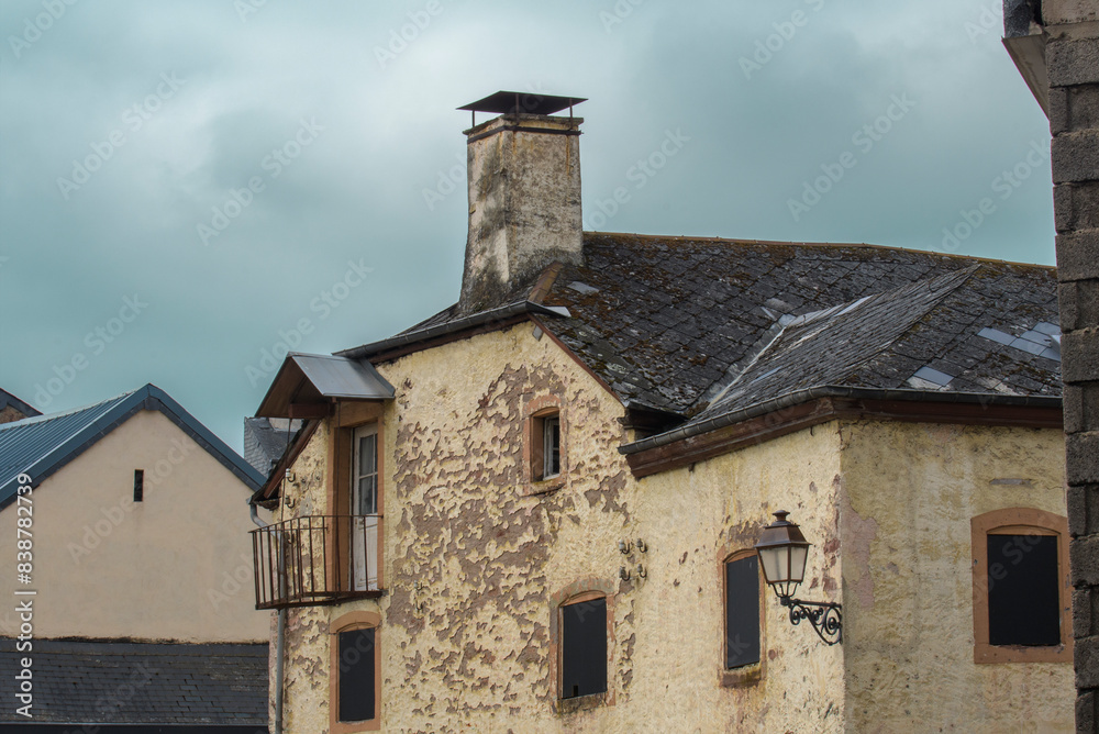 Fragment of an old house in western Europe. Leaning walls, peeling plaster on the walls. Fragment of an old house in western Europe. Leaning walls, peeling plaster on the walls.