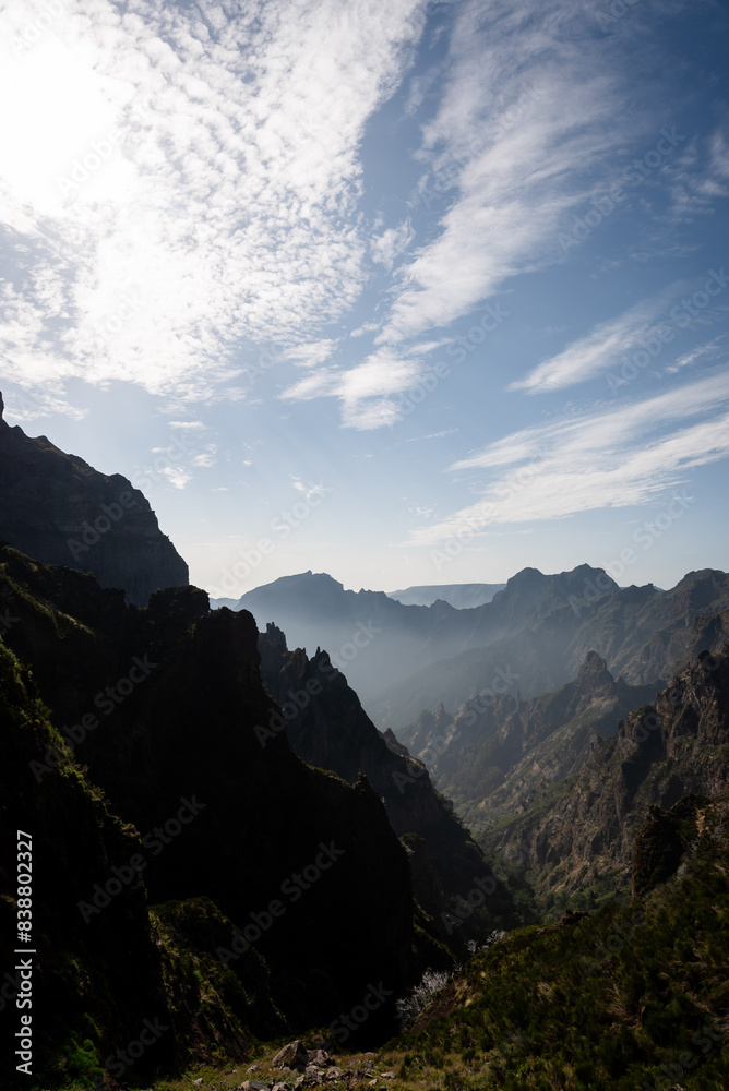 Fototapeta premium the sun sets in over the mountains above a valley below