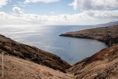 a large body of water sitting on top of a grass covered hillside