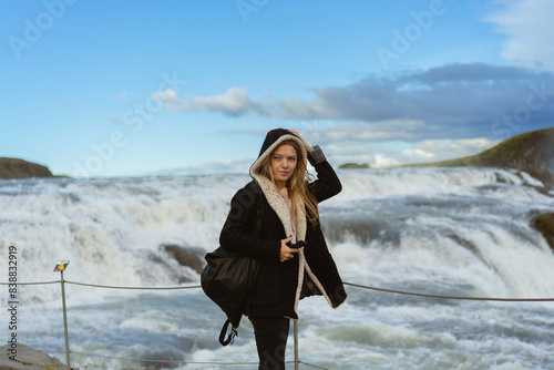Woman tourist in Gullfoss waterfall, in Iceland.