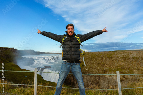 Man tourist in Gullfoss waterfall, in Iceland.