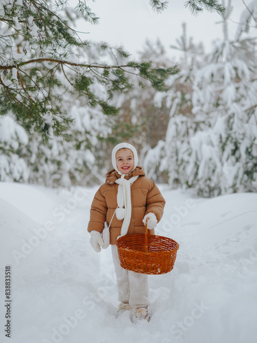 Canvas Print A little girl in the winter forest walks