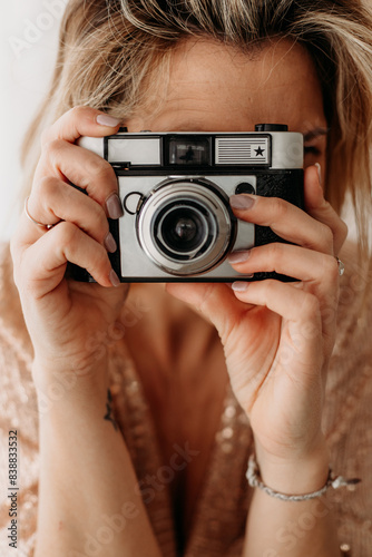 Close-Up of Woman Holding Vintage Camera © Cavan