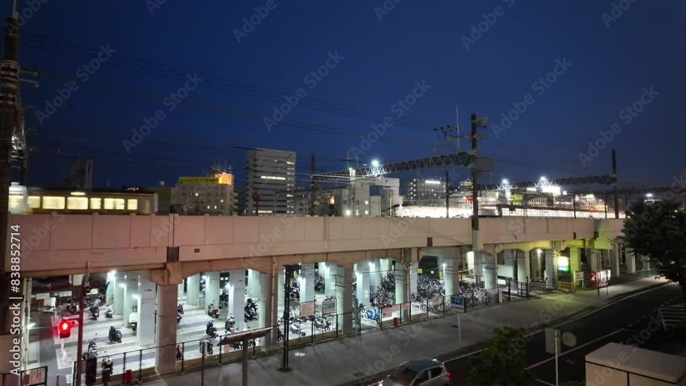 Night scene of Hamamatsu city with passing trains and bicycle parking Night scene of Hamamatsu city with passing trains and bicycle parking