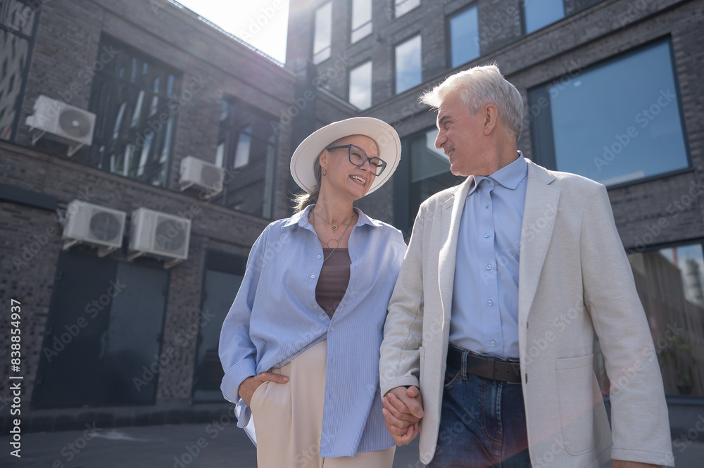 An elderly couple in love walks through the city. An elderly couple in love walks through the city.