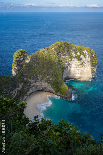 Island with scattered rocks in clear blue water in Kampung Tarung, Sumba Island, Indonesia photo