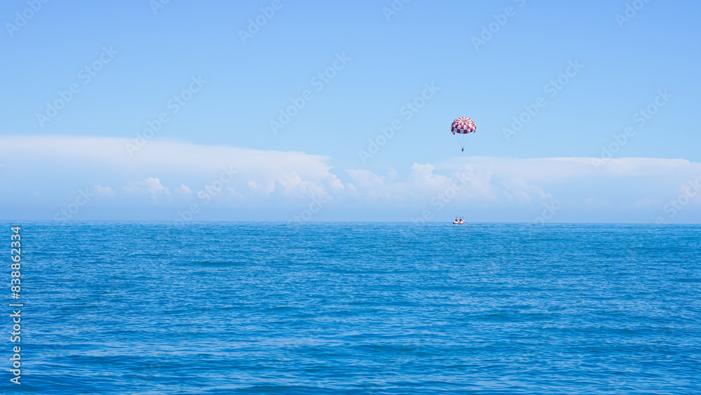 Thrilling parachute boat flight over the ocean, an unforgettable adventure. Thrilling parachute boat flight over the ocean, an unforgettable adventure.