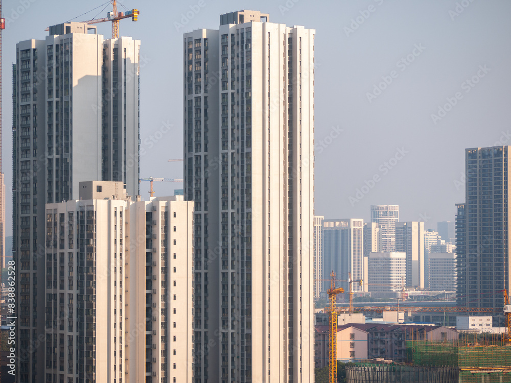Obraz premium Construction site of high-rise residential apartment building. Some tall, modern residences in City of Liuzhou, Guangxi, China. Concept of Real estate development, housing and Chinese economy