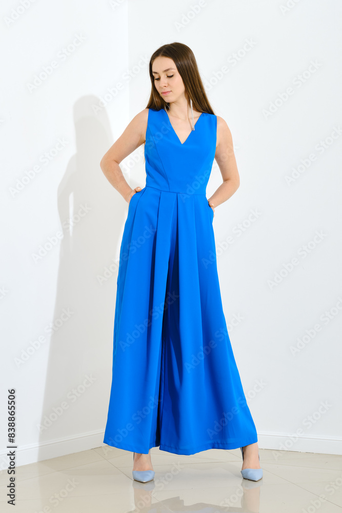 Pretty woman in blue long sleeveless dress Pretty woman in blue long sleeveless dress