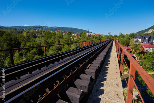 View on railway bridge above the Prut river. Beauteful autumn in Carpathian mountains, Ukraine photo