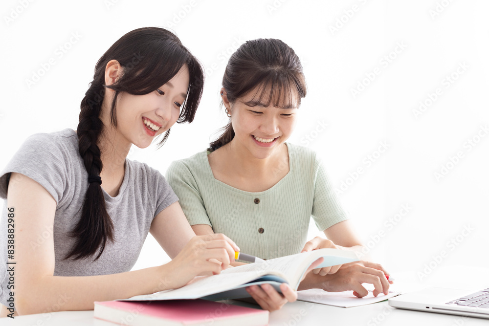 Two students doing homework together and helping each other Two students doing homework together and helping each other