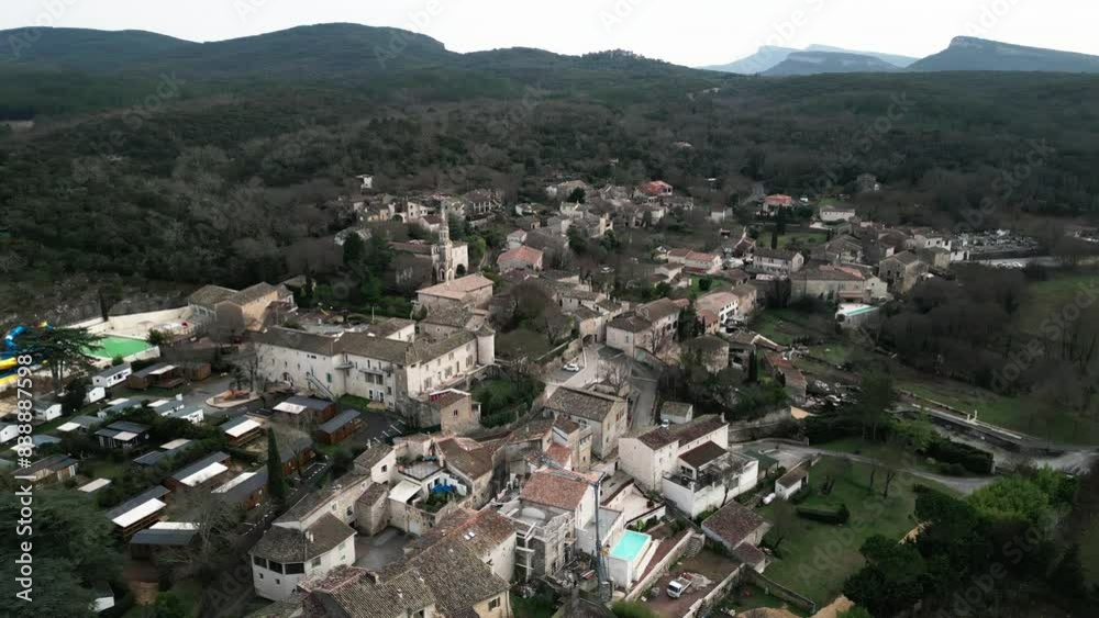 drone aerial shot of the town of Allegre les fumares in France among the mountains on a cloudy day where you can see all its architecture drone aerial shot of the town of Allegre les fumares in France among the mountains on a cloudy day where you can see all its architecture