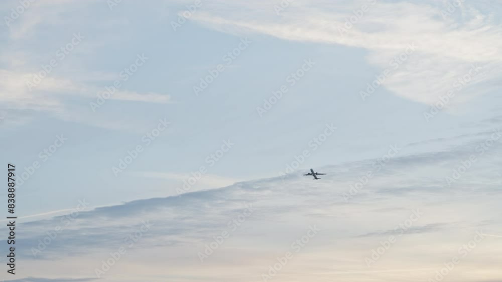 Departure of an airplane from munich airport in front of a beautiful morning-lit blue sky and moody clouds. Departure of an airplane from munich airport in front of a beautiful morning-lit blue sky and moody clouds.
