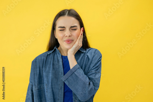 Φωτογραφία Young miserable woman experiencing severe toothache, pressing palm to cheek, clo