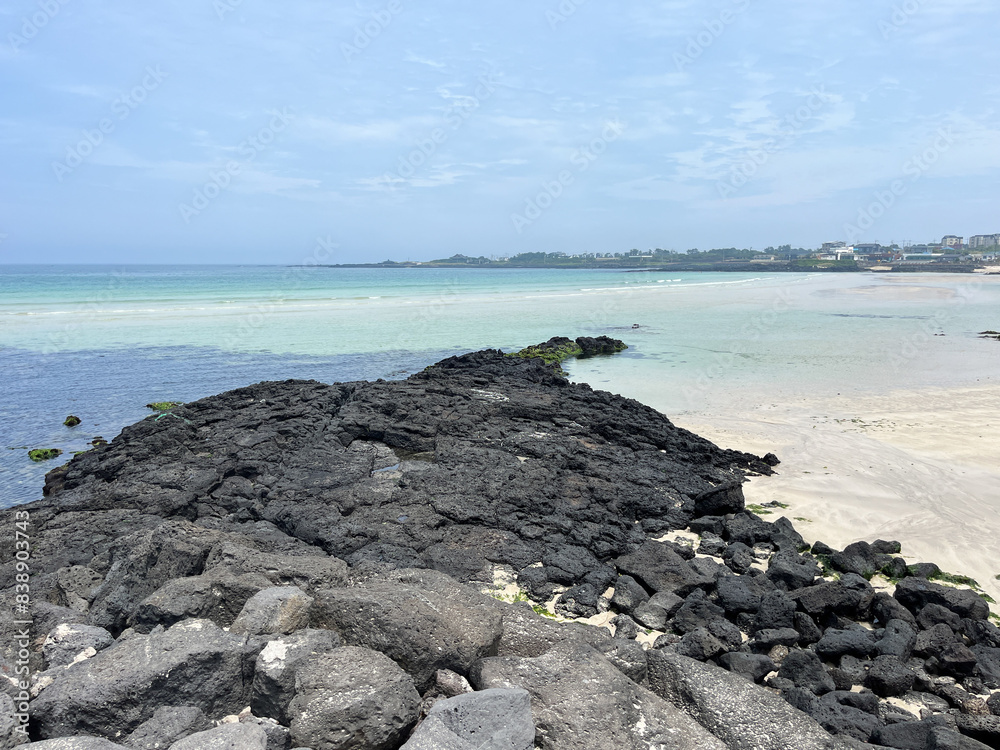 Volcano rocks and coral sand at Beach of Jeju Island at Jeju-do, South Korea Volcano rocks and coral sand at Beach of Jeju Island at Jeju-do, South Korea
